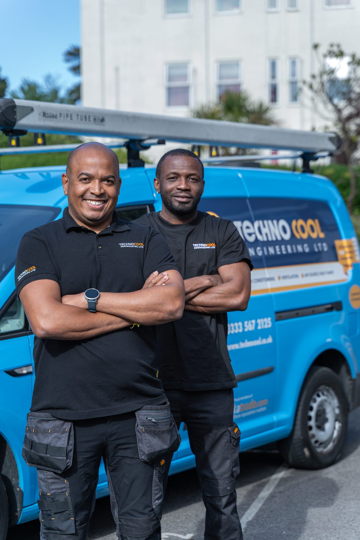 TechnoCool team standing in front of branded company van